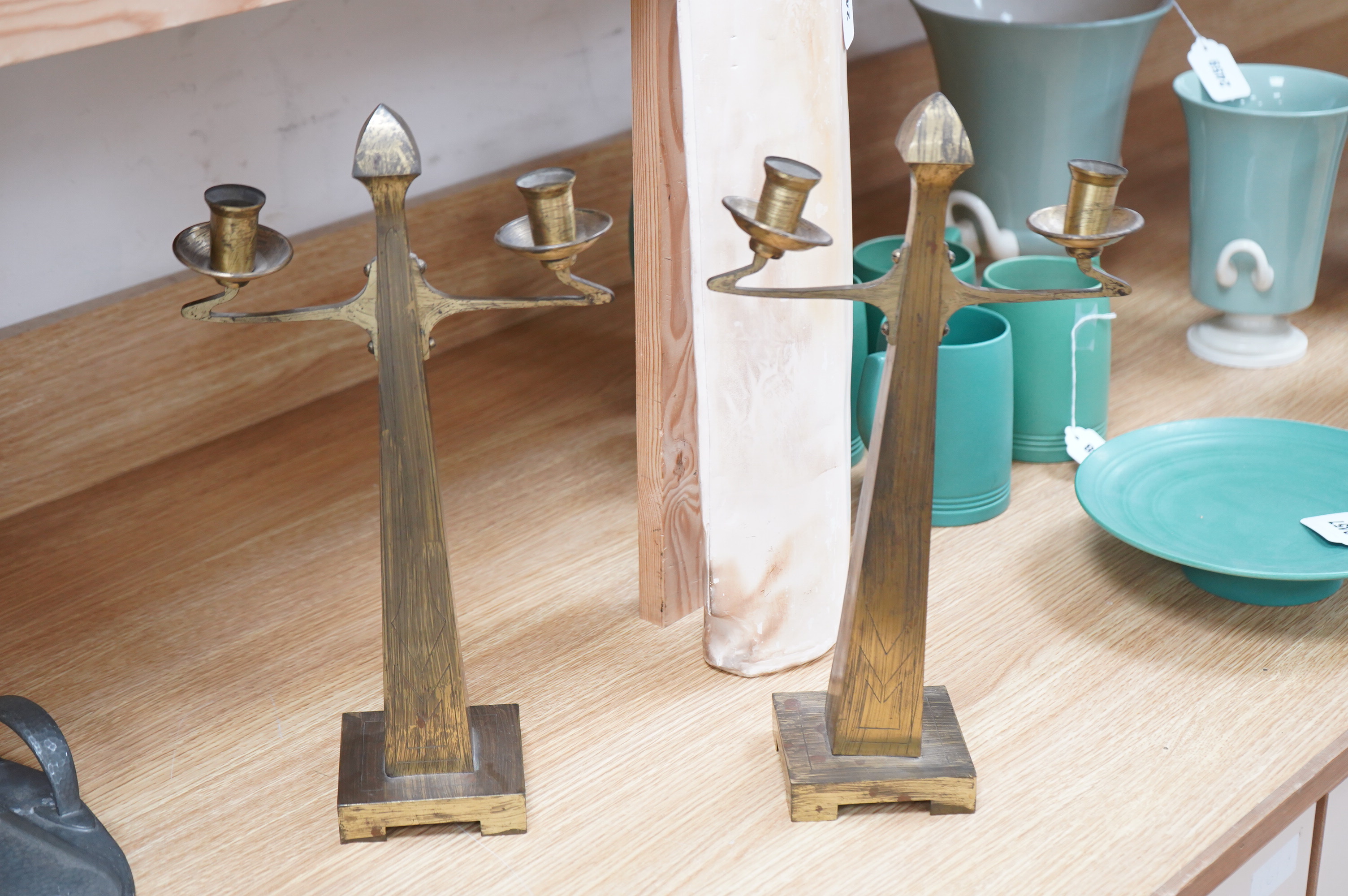 A pair of Jugendstil Arts and Crafts brass two branch candelabra, 37cm high